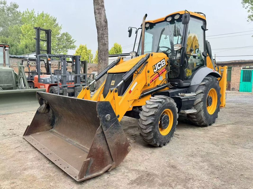 Excavadora de retroexcavadora JCB 3CX usada con cubo dividido y brazo extendido